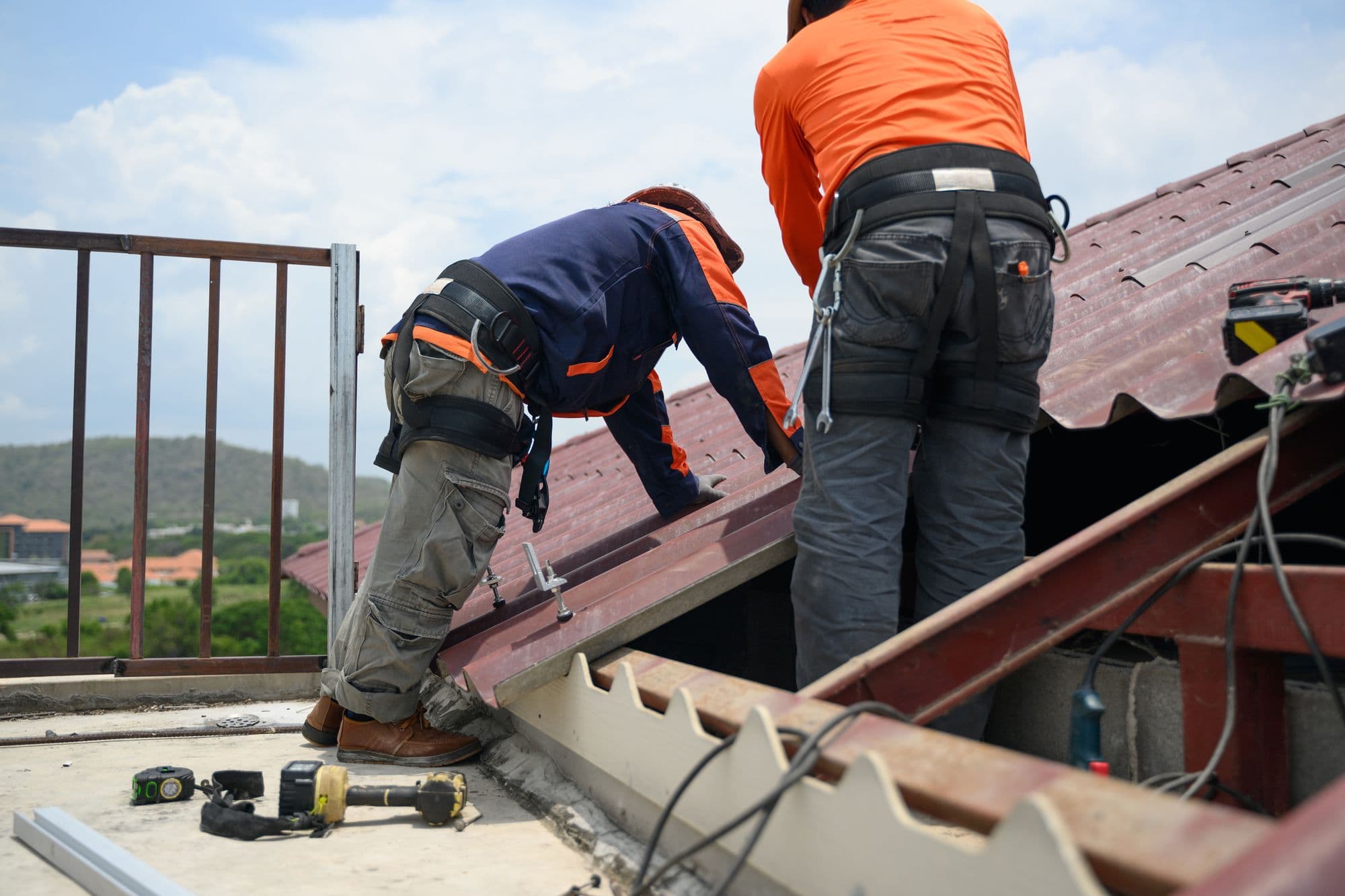 Roofing team working on a metal roof