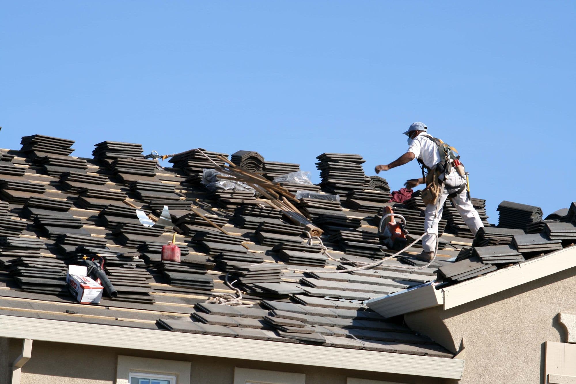 Roofer laying concrete tile on a home